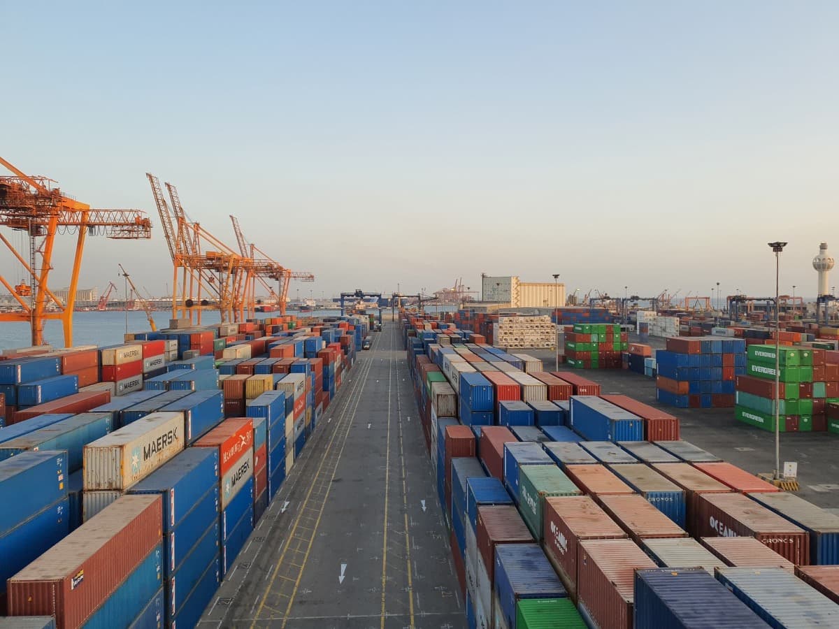 Containers, cranes, and internal lanes in a cargo port